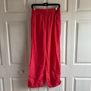 ATHLETA Rise Pant XS Punch Bungee Hem Zip Pocket Nylon Blend Run Gym Hiking Pink